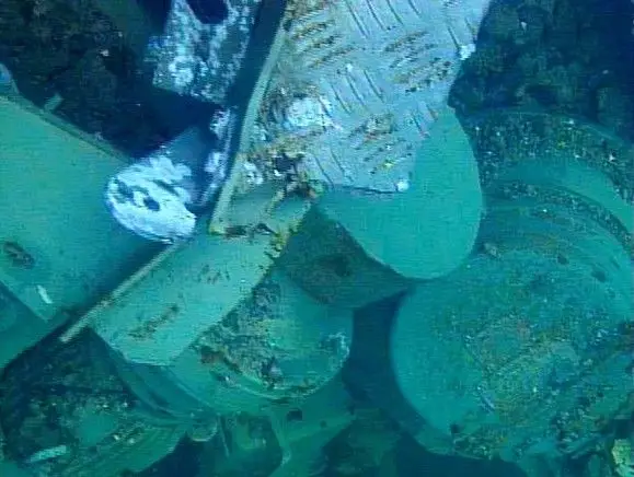 Part-of-the-fallen-fuel-hoist--an-electric-motor--is-seen-i.jpg